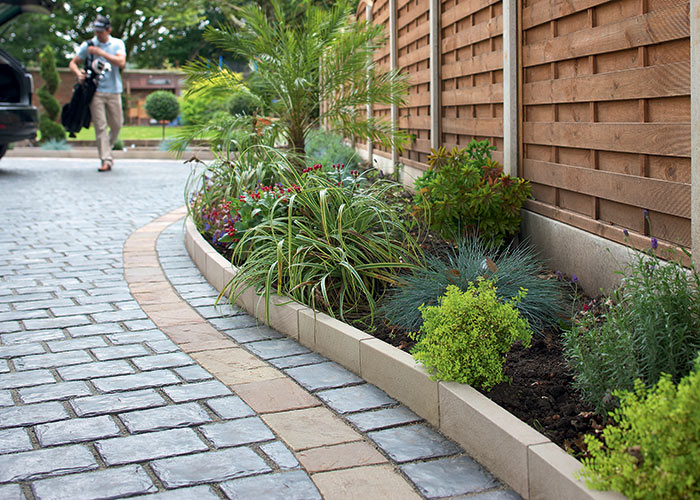 Photo of new paved driveway, landscaping and fencing