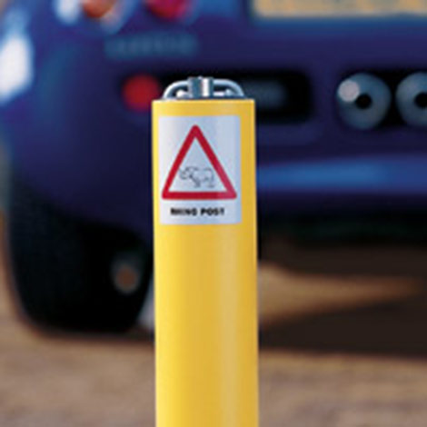 Photo showing yellow security drive post